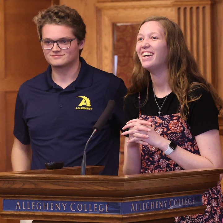Hans Vanderzyden and Emma Chambers presenting their research at an Allegheny College podium